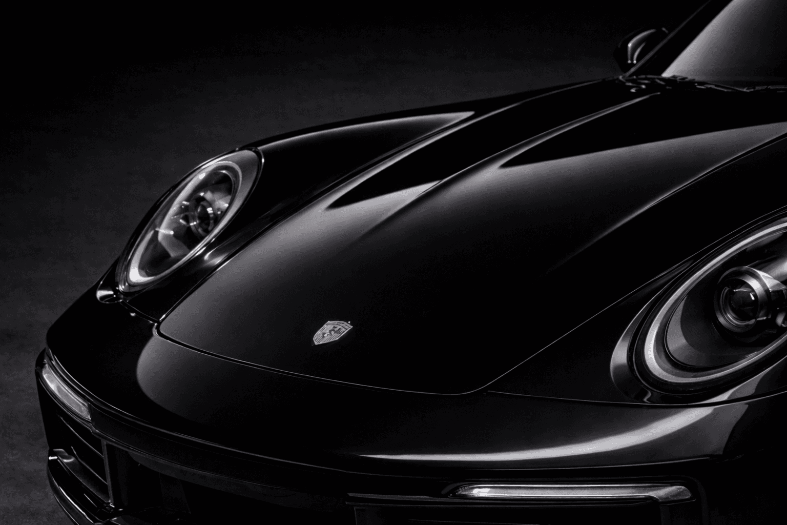 Close-up of the same black car front panel with a clean glossy finish